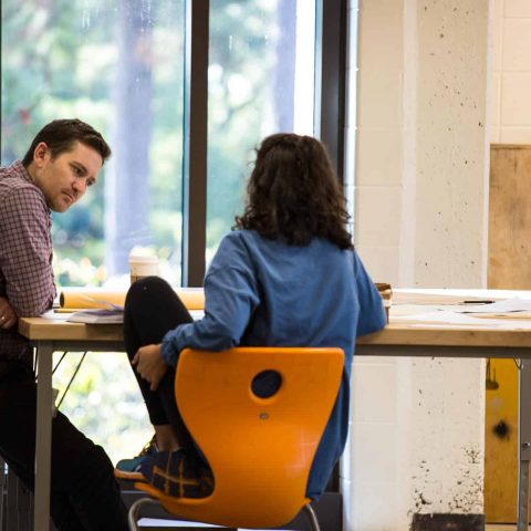 Professor Justin Miller speaking to architecture student