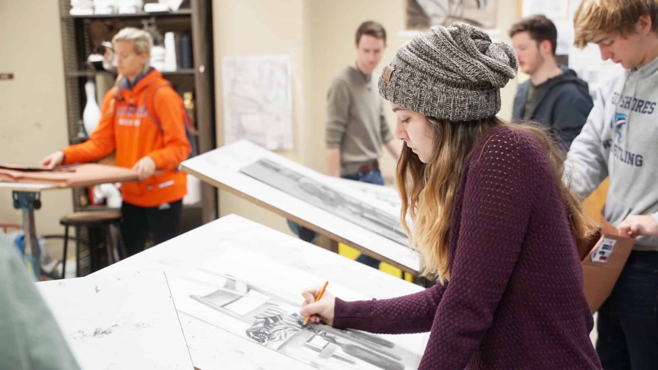 Graphic Design student drawing in studio