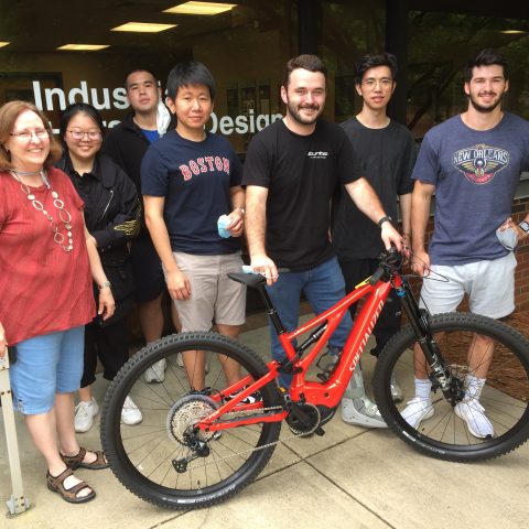 Students and faculty with e-bike