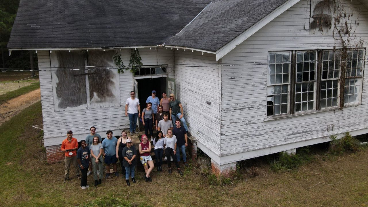 15 Auburn University Students and two faculty members standing in front of the Tankersley Rosenwald School