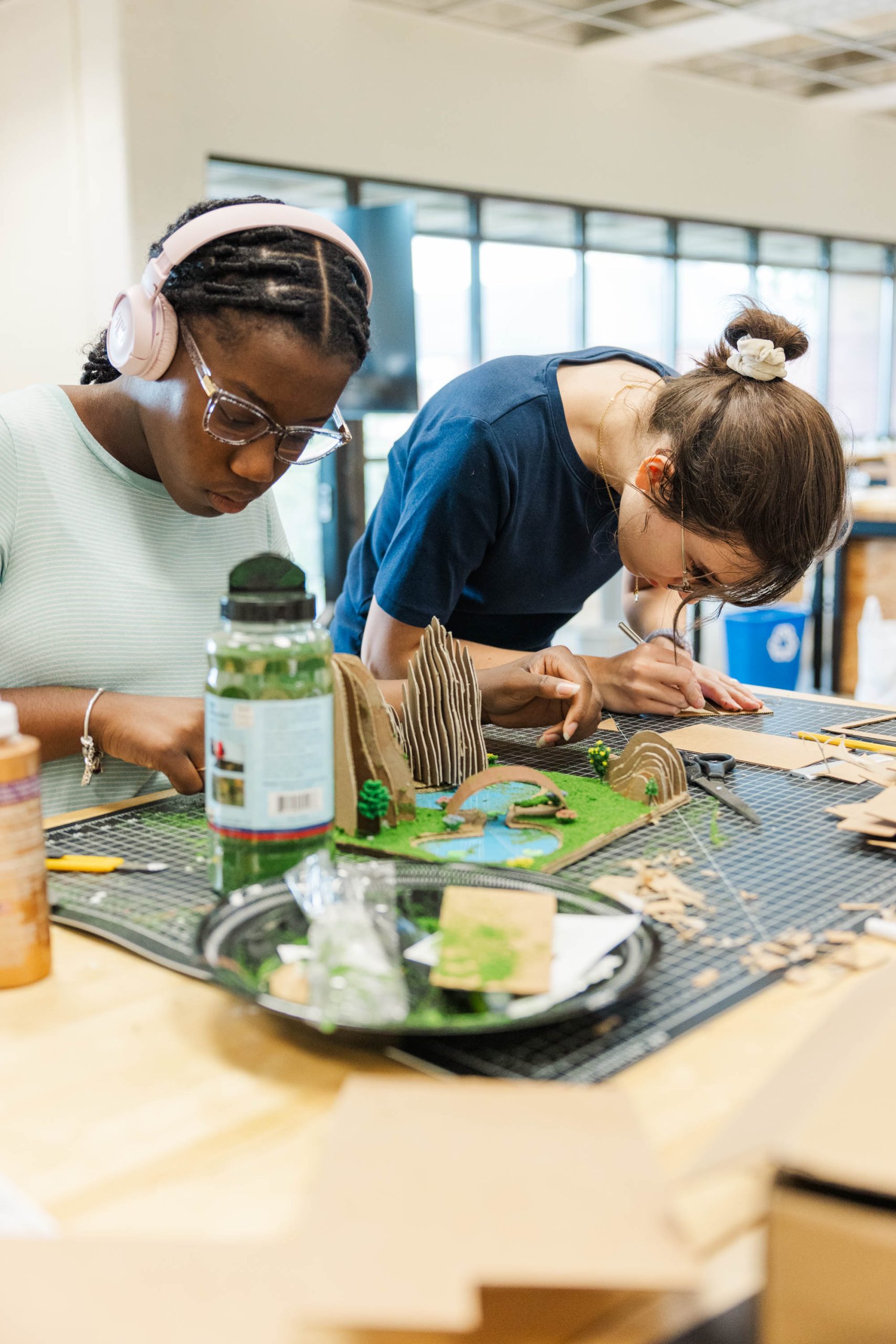 two students working on a Landscape Architecture model in studio