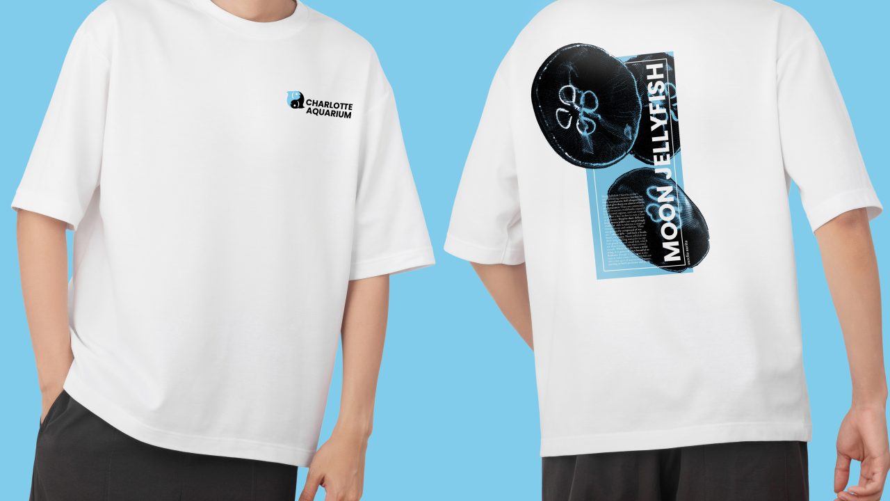 A person wearing a white t-shirt with Charlotte Aquarium text and logo on the front, and an image of jellyfish with Moon Jellyfish text on the back.