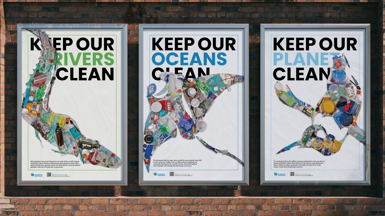 Three posters on a brick wall show aquatic animals made from plastic waste with the messages: Keep our rivers clean, Keep our oceans clean, and Keep our planet clean.