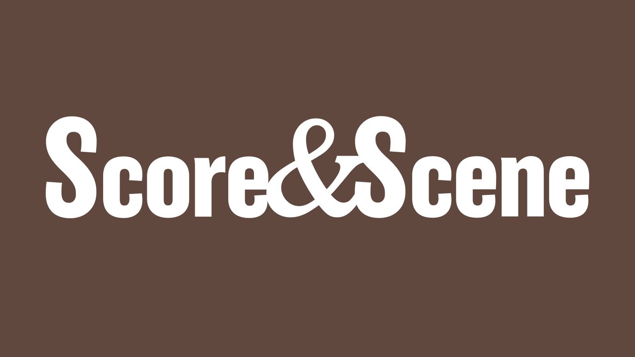 White text Score&Scene in bold font on a solid brown background.
