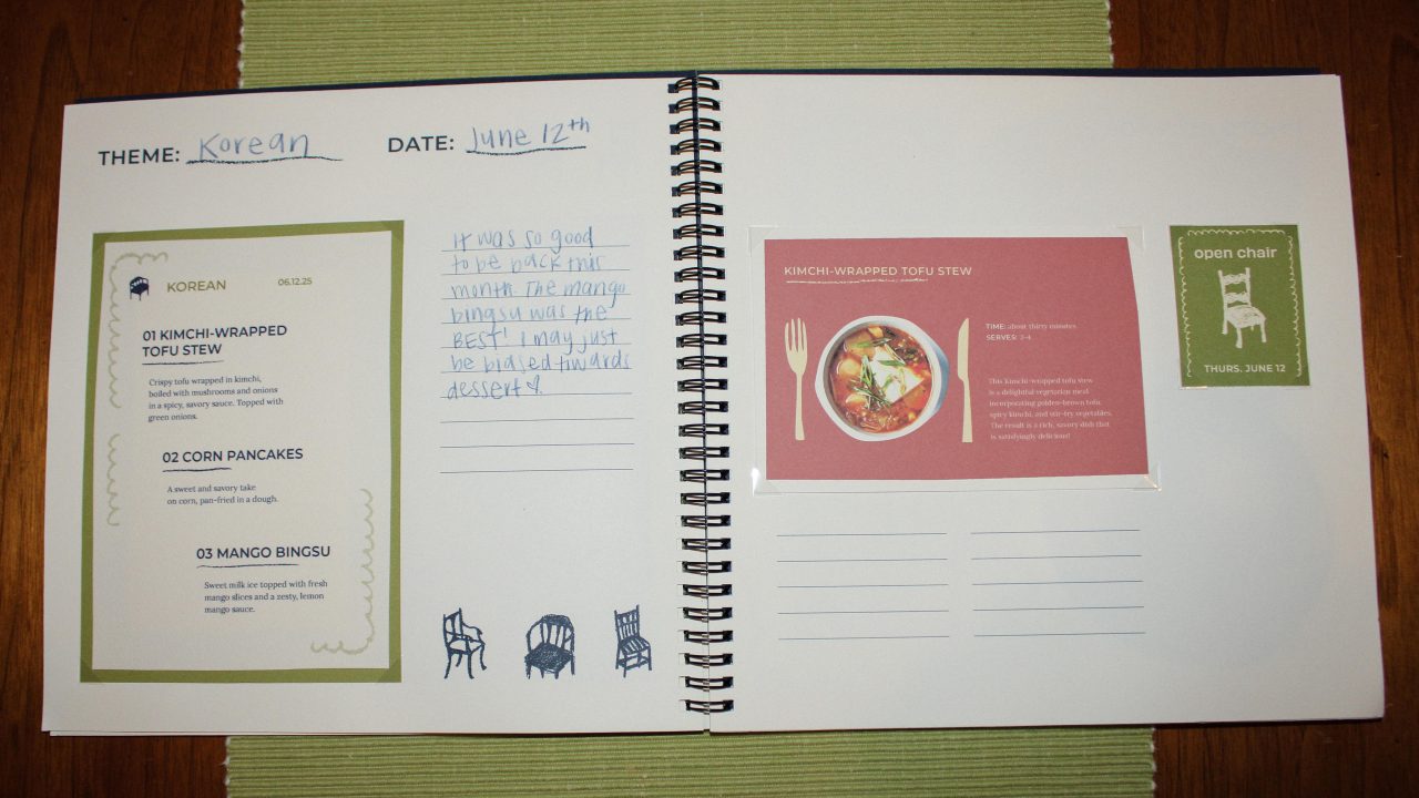 Open scrapbook to a spread featuring a Korean-themed meal, dated June 12th, with recipes, a food photo, handwritten notes, and a green event card on a wooden table.