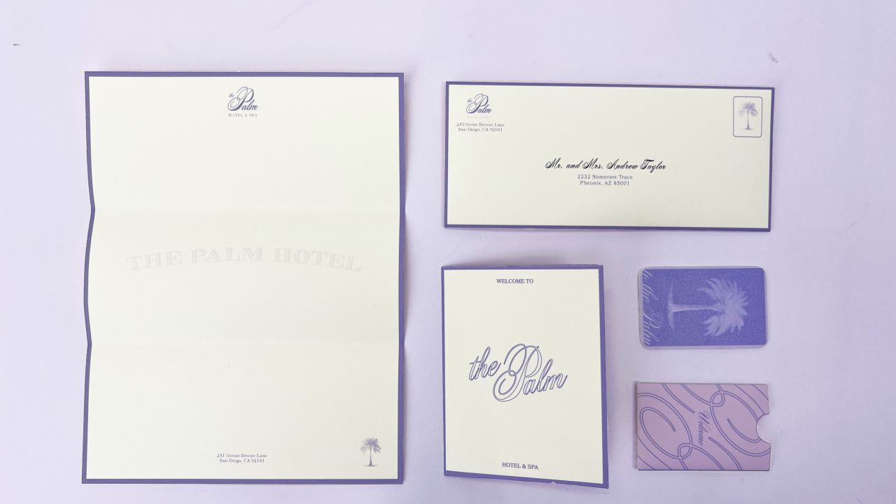 A set of hotel stationery from The Palm Hotel, including a folded letter, envelope, welcome card, key card sleeve, and two key cards, all in white and purple tones.