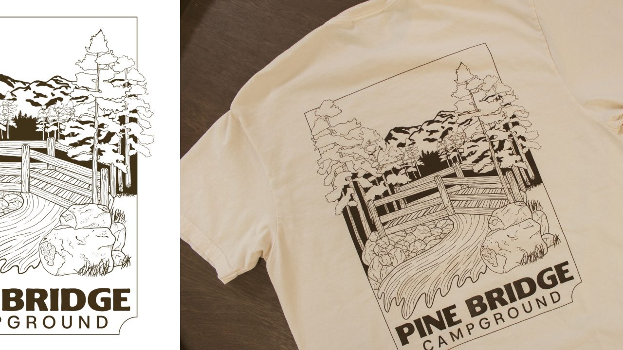 Line art of a wooden bridge over a stream with trees and mountains, labeled Pine Bridge Campground, printed on a light-colored T-shirt.
