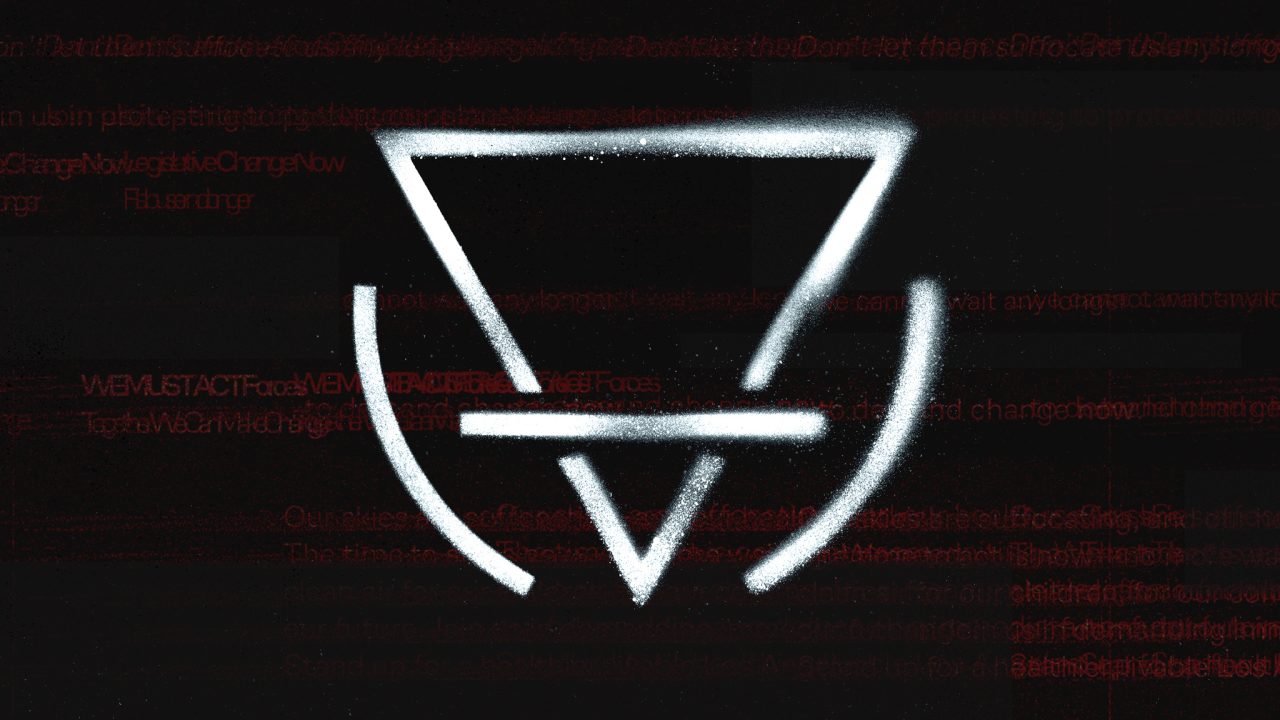A white geometric symbol is spray-painted on a dark surface with faint red text in the background.