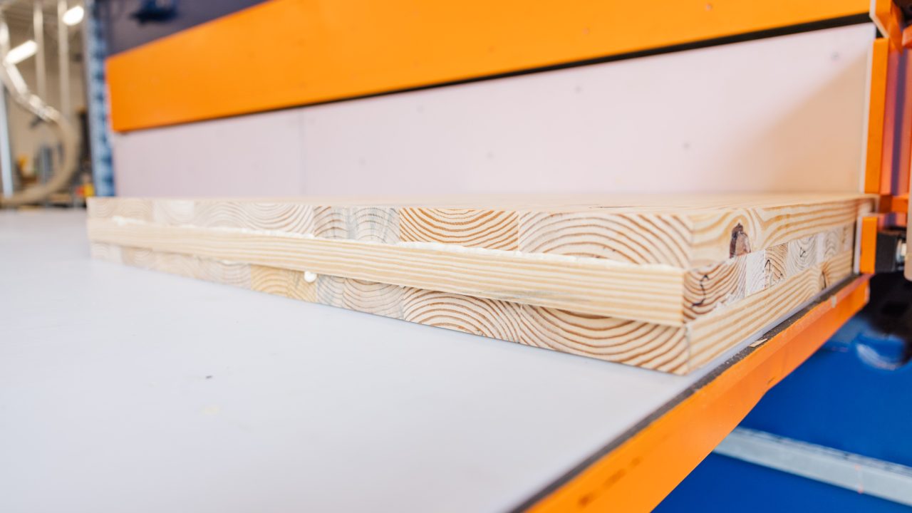 Cross-laminated timber in a press at the CADC Research Commons