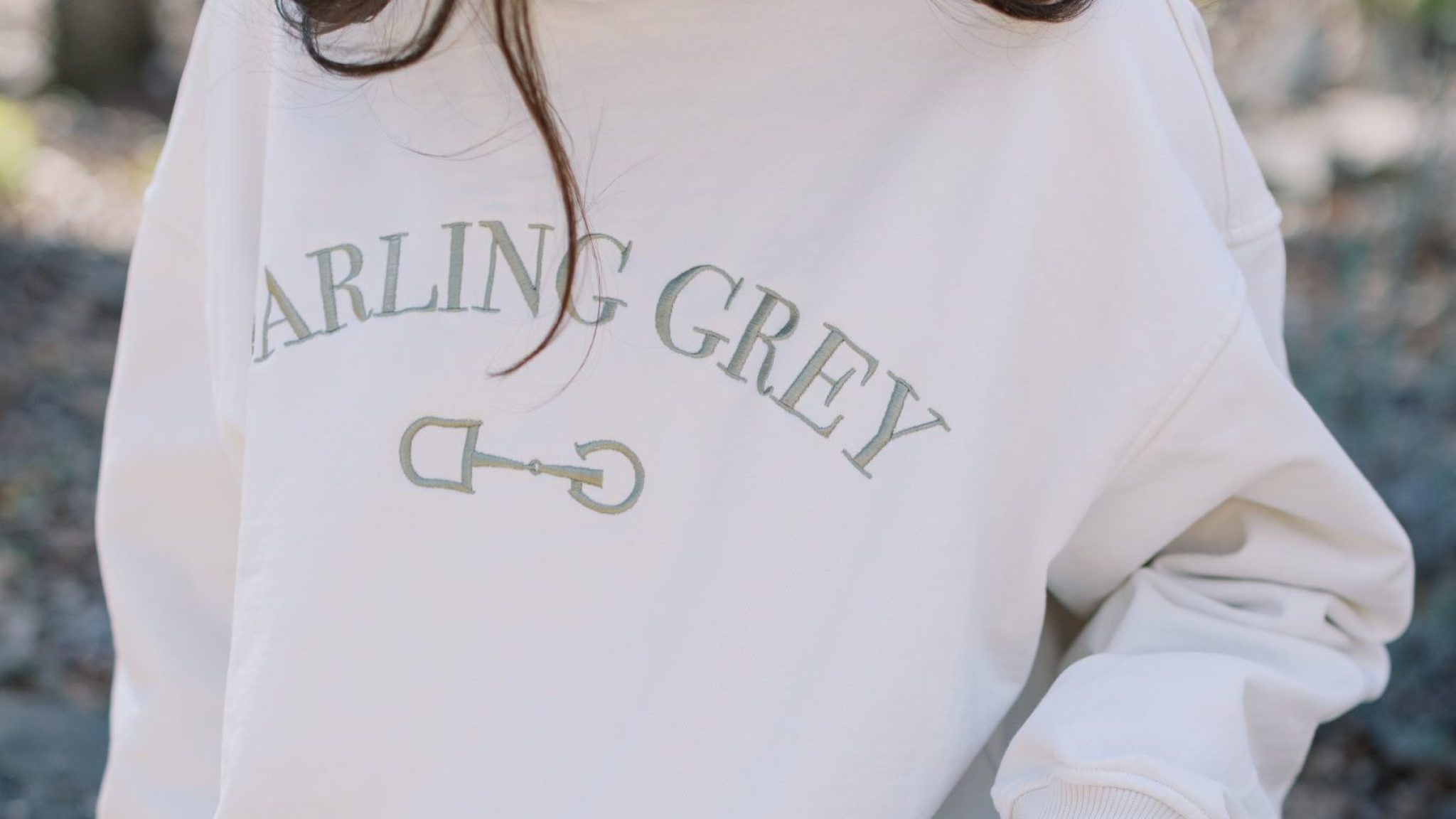 Model wearing a Darling Grey sweatshirt designed by Anna Grace Wesson '24