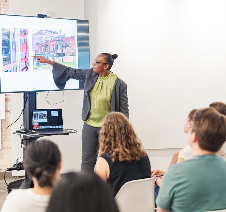 Nolanda Hatcher of Studio 2H Design presents an adaptive reuse project to students during their visit.