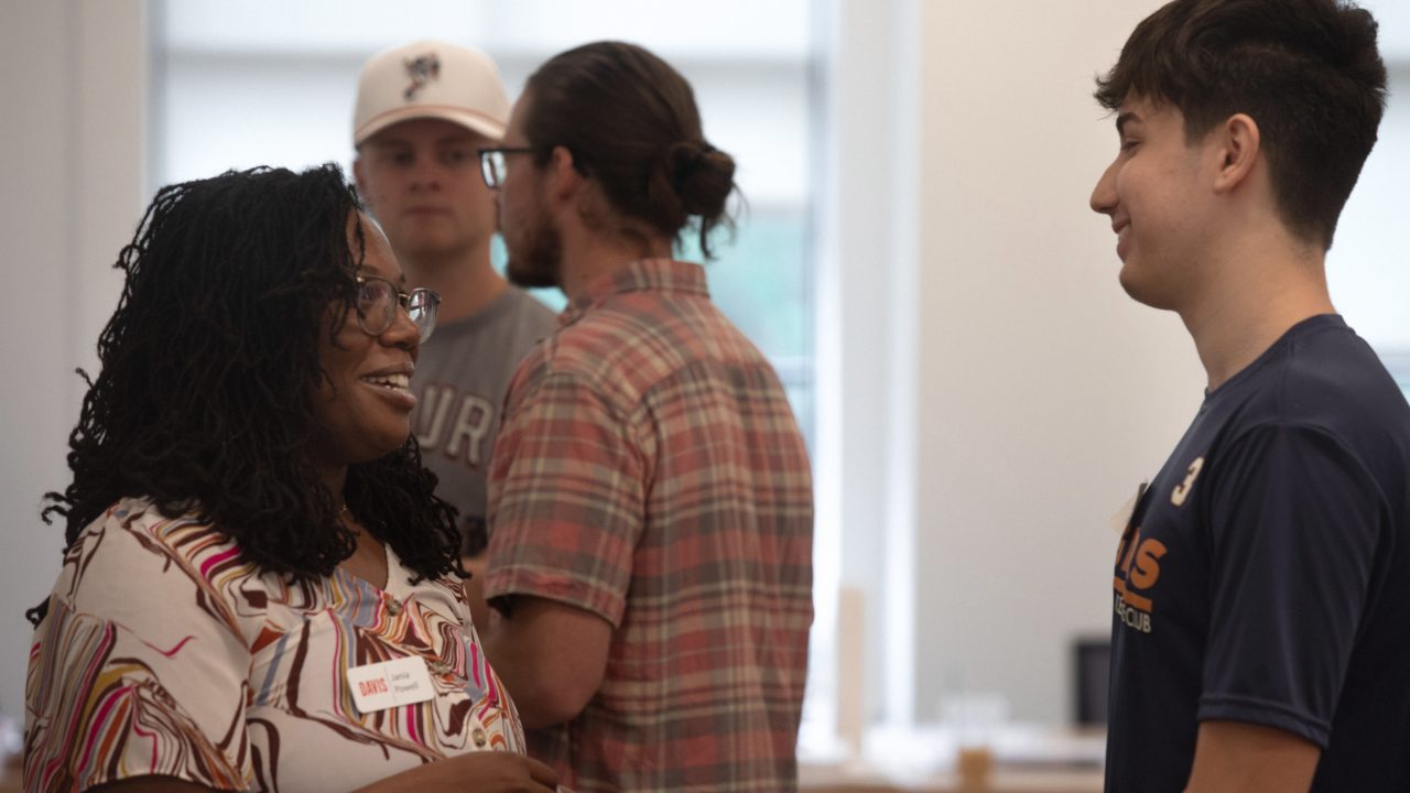 Jania Powell of Davis Architects, left, speaks with Auburn University student Javier Wurster during the Urban Studio Welcome Back Breakfast in Auburn, Ala.