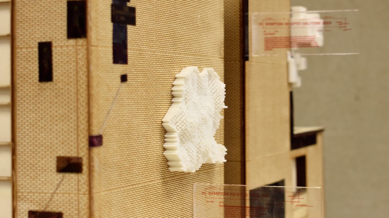 Auburn University Environmental Design student work A close-up of a cardboard architectural model with a white, cloud-like structure attached to a building façade and transparent rectangular panels extending from it.