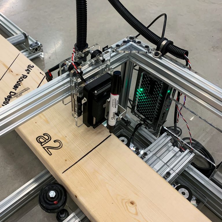 The machine outlines where different lumber pieces get connected on site. | Photo by Cait McCarthy