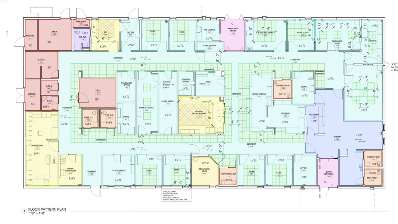 Architectural floor plan showing multiple offices, meeting rooms, restrooms, and common areas arranged around central corridors, with color-coded sections and labeled room numbers.