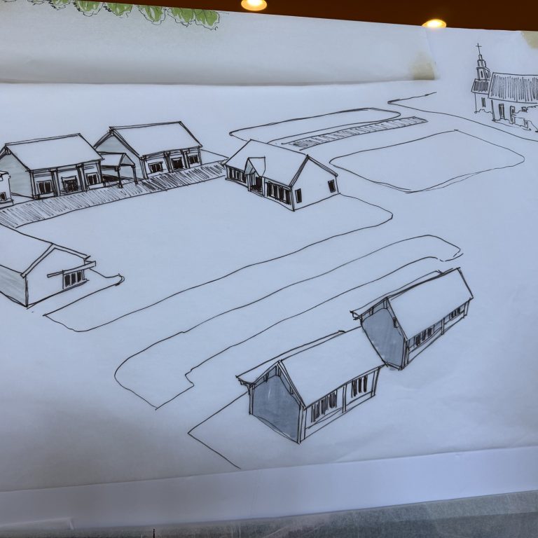 A hand-drawn architectural sketch shows several buildings and a church with open land and roads, viewed from an angled perspective.