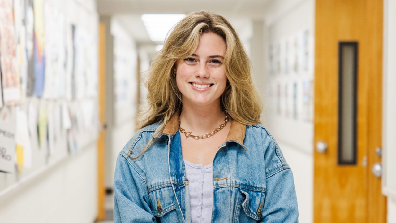 Lavens Maginnis standing in a hallway in Wallace Hall
