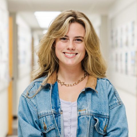 Lavens Maginnis standing in a hallway in Wallace Hall