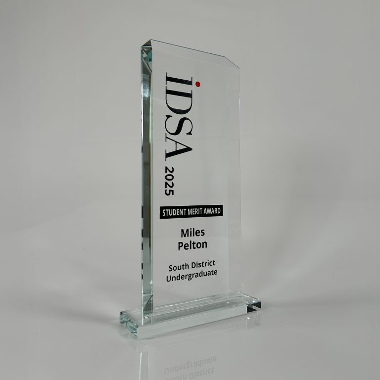 A glass award trophy with the text: IDSA 2025 Student Merit Award, Miles Pelton, South District Undergraduate.