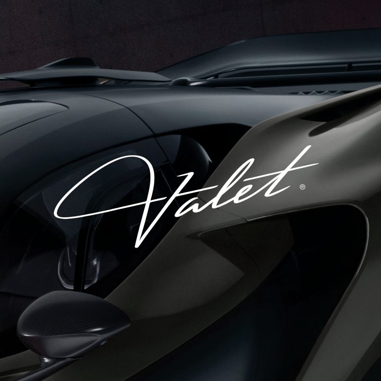 Close-up of a luxury car interior and exterior with the word Valet in stylized white script across the image.