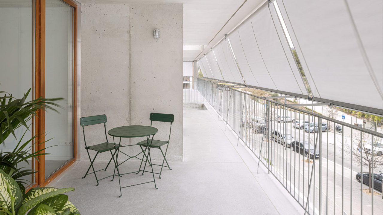 Sunshades run along the street facade for passive cooling of the units. | Photo by Adria Goula