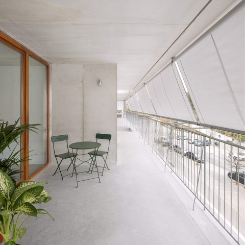 Sunshades run along the street facade for passive cooling of the units. | Photo by Adria Goula