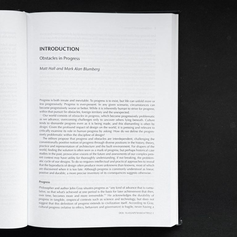 Open book showing a page titled INTRODUCTION: Obstacles in Progress by Matt Hall and Mark Alan Blumberg, with printed text in black on a white background.