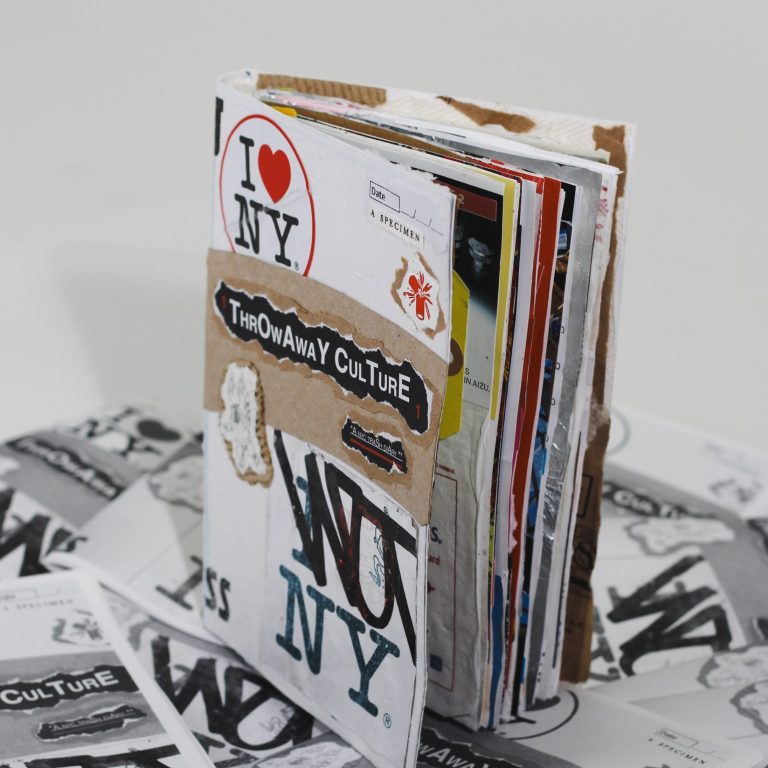 A handmade collage zine titled Throwaway Culture stands upright on a pile of similar printed materials, featuring cut-out images, stickers, and various layered textures.