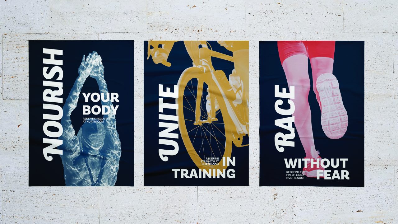 Three athletic posters: a swimmer with NOURISH YOUR BODY, a cyclist with UNITE IN TRAINING, and a runner with RACE WITHOUT FEAR on a light stone wall.