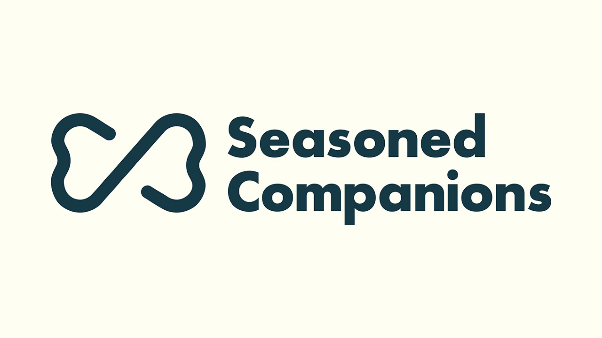 Logo for Seasoned Companions featuring a stylized bone icon to the left of the brand name in bold, dark lettering on a light background.