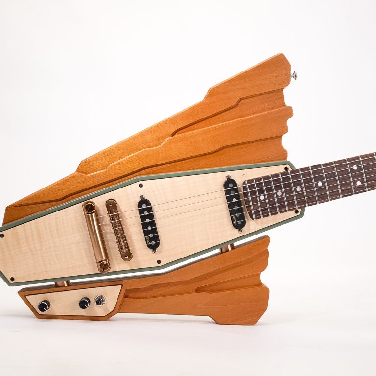 An electric guitar with a unique, angular wooden body design, two pickups, control knobs, and a dark fingerboard against a plain white background.