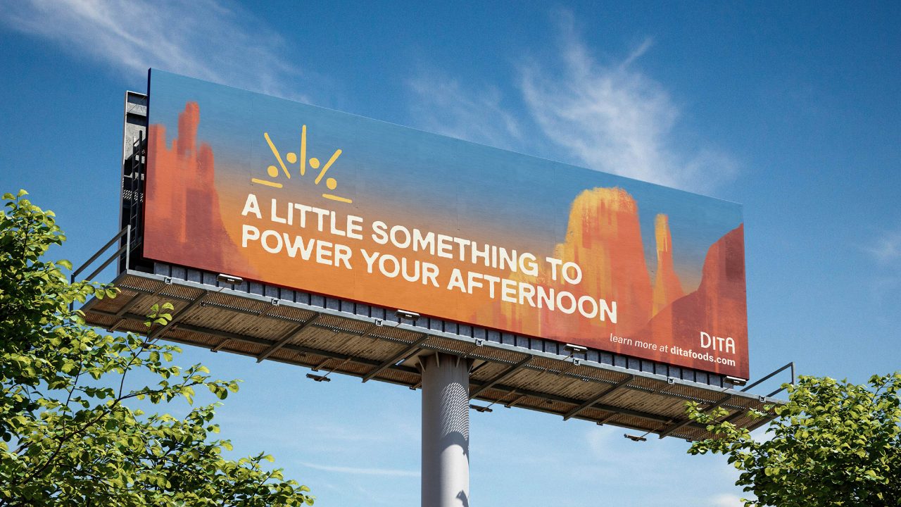 A billboard above trees with a desert-themed background reads, A LITTLE SOMETHING TO POWER YOUR AFTERNOON, and includes the DITA logo and a website link.