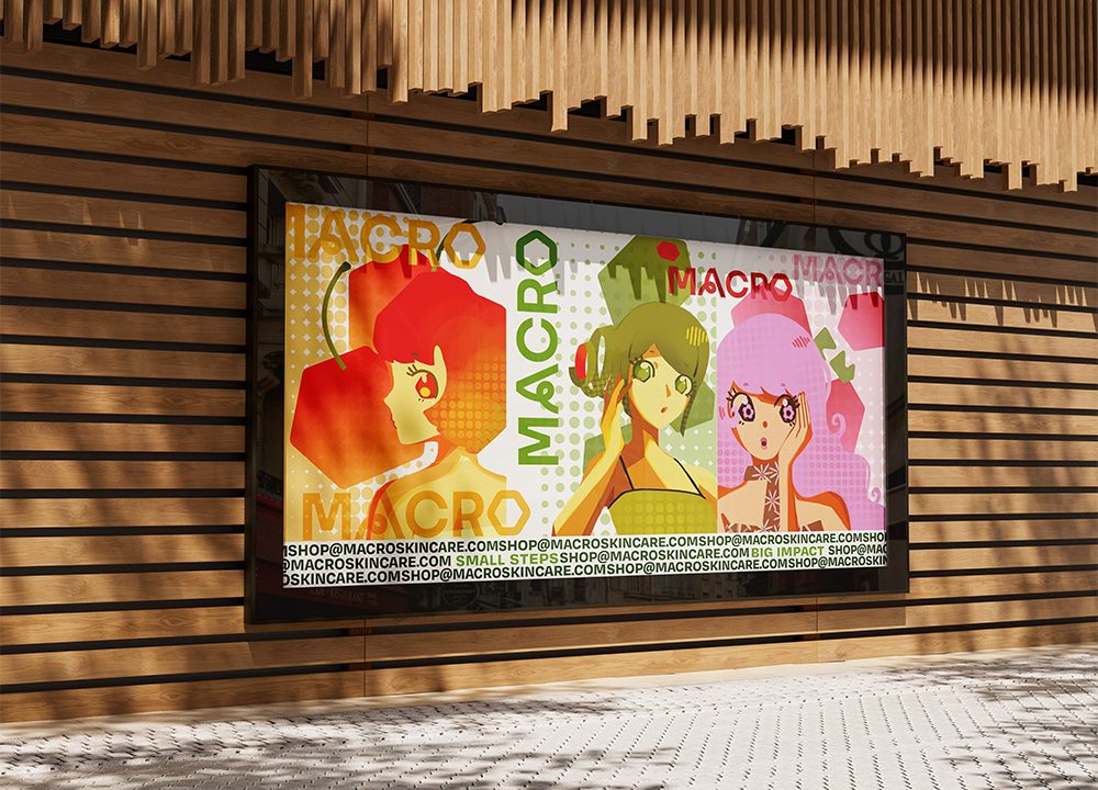 A large poster on a wooden wall displays three illustrated women with colorful hair and the word MACRO repeated in the design.