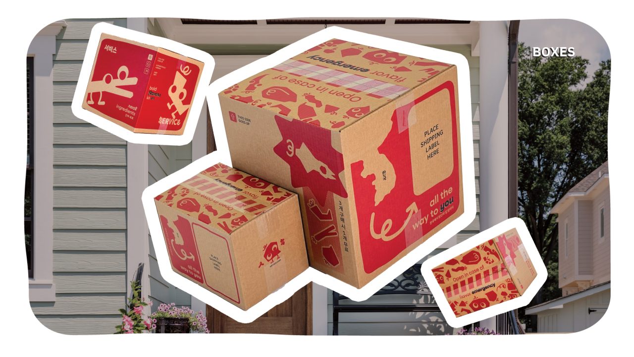 Two cardboard boxes with red, playful graphics and instructions are placed outside a house. Smaller insets show close-up views of the box designs and text.