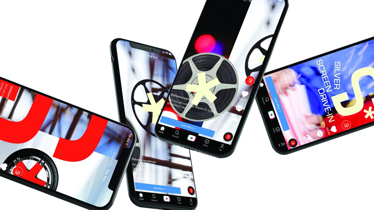 Five smartphones display various streaming app interfaces featuring film reels, movie-related graphics, and vibrant colors on their screens, all against a white background.