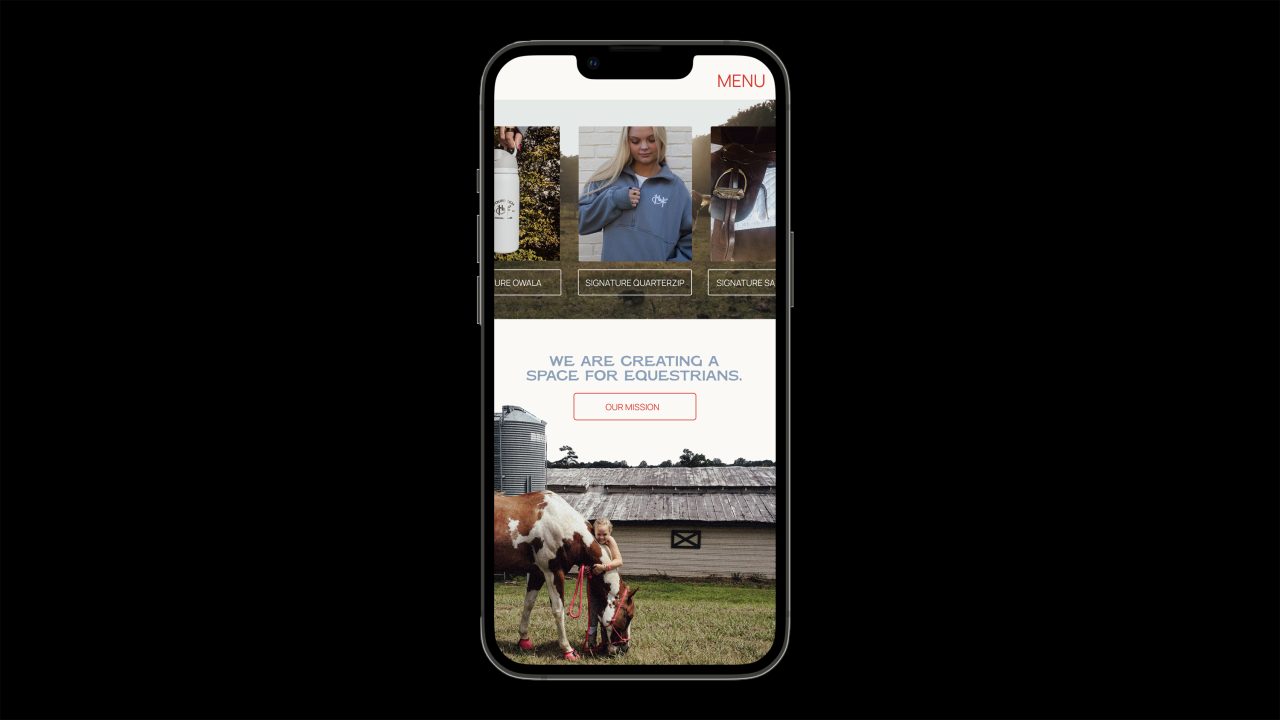 A smartphone displays a website with images of people, a mission statement about creating space for equestrians, and a photo of a horse eating grass near a barn.