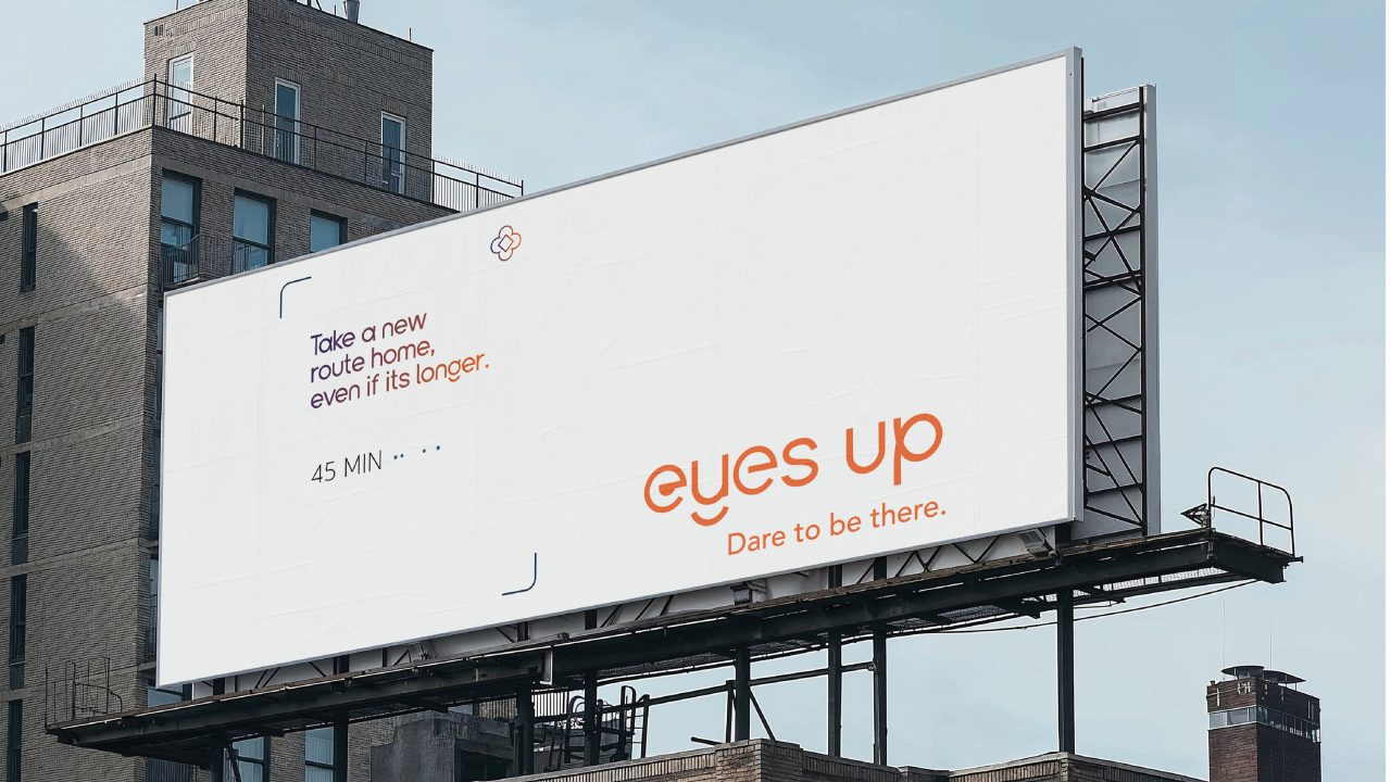 A large outdoor billboard reads: “Take a new route home, even if it’s longer. 45 MIN... eyes up Dare to be there.” in orange and black text on a white background.