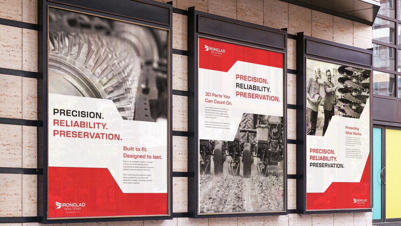 Three posters on a building wall promote Ironclad, highlighting precision, reliability, and preservation with images of machinery and workers in industrial settings.