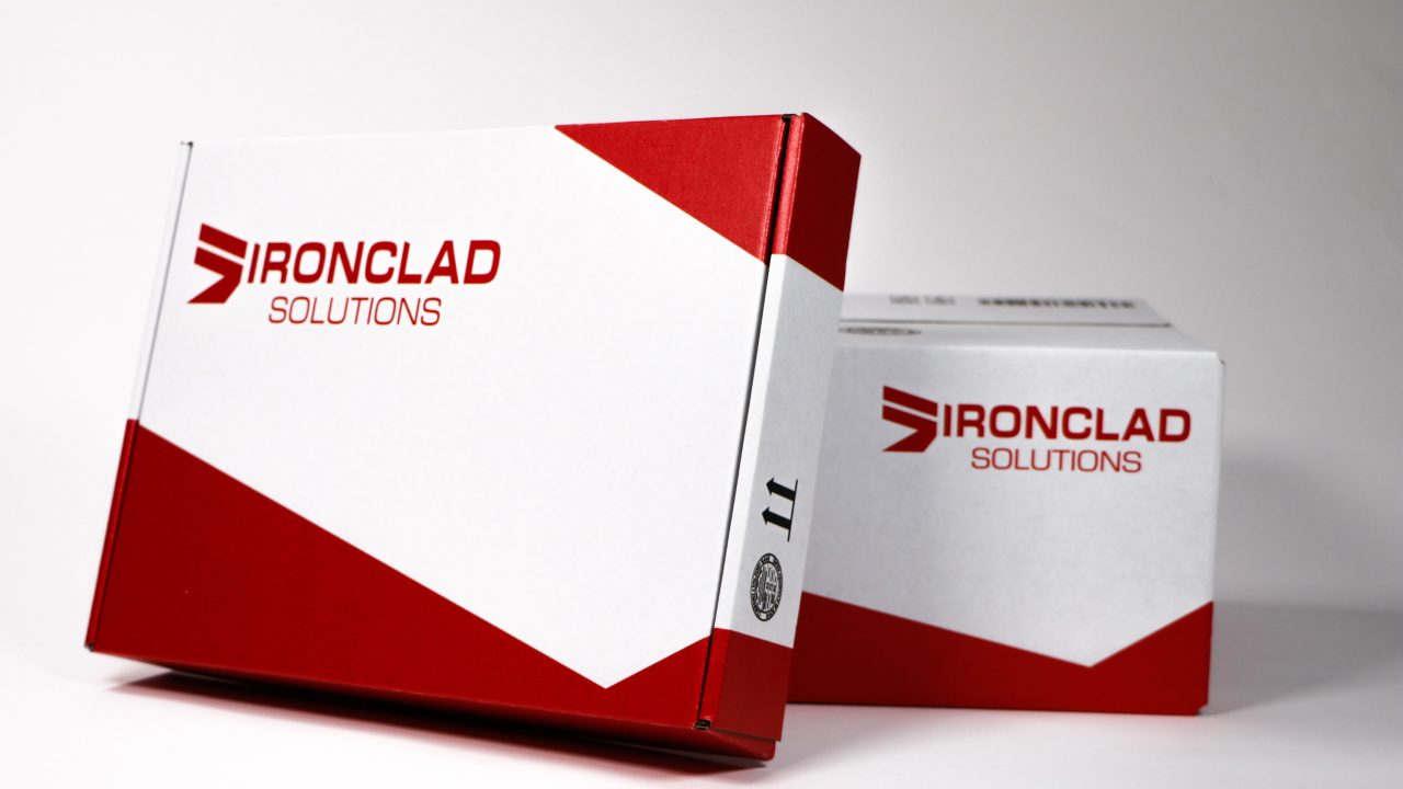 Two shipping boxes with a red and white design, both labeled IRONCLAD SOLUTIONS, are positioned on a plain light background.