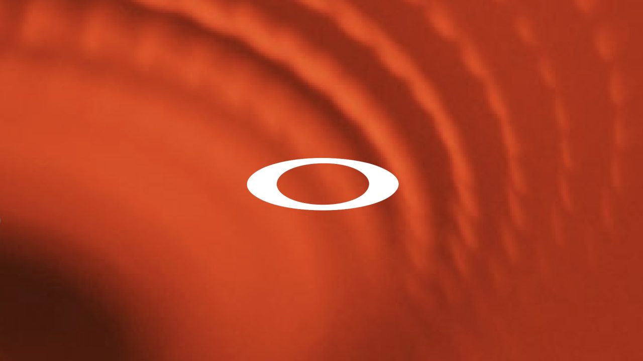 A white oval shape is centered against a red background with circular, ripple-like patterns.
