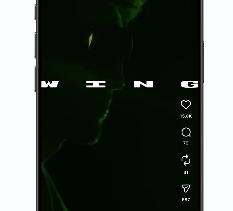 Smartphone screen displaying an Instagram Reel with a dark, green-tinged image, partial word WING, and visible engagement icons and counts on the right side.