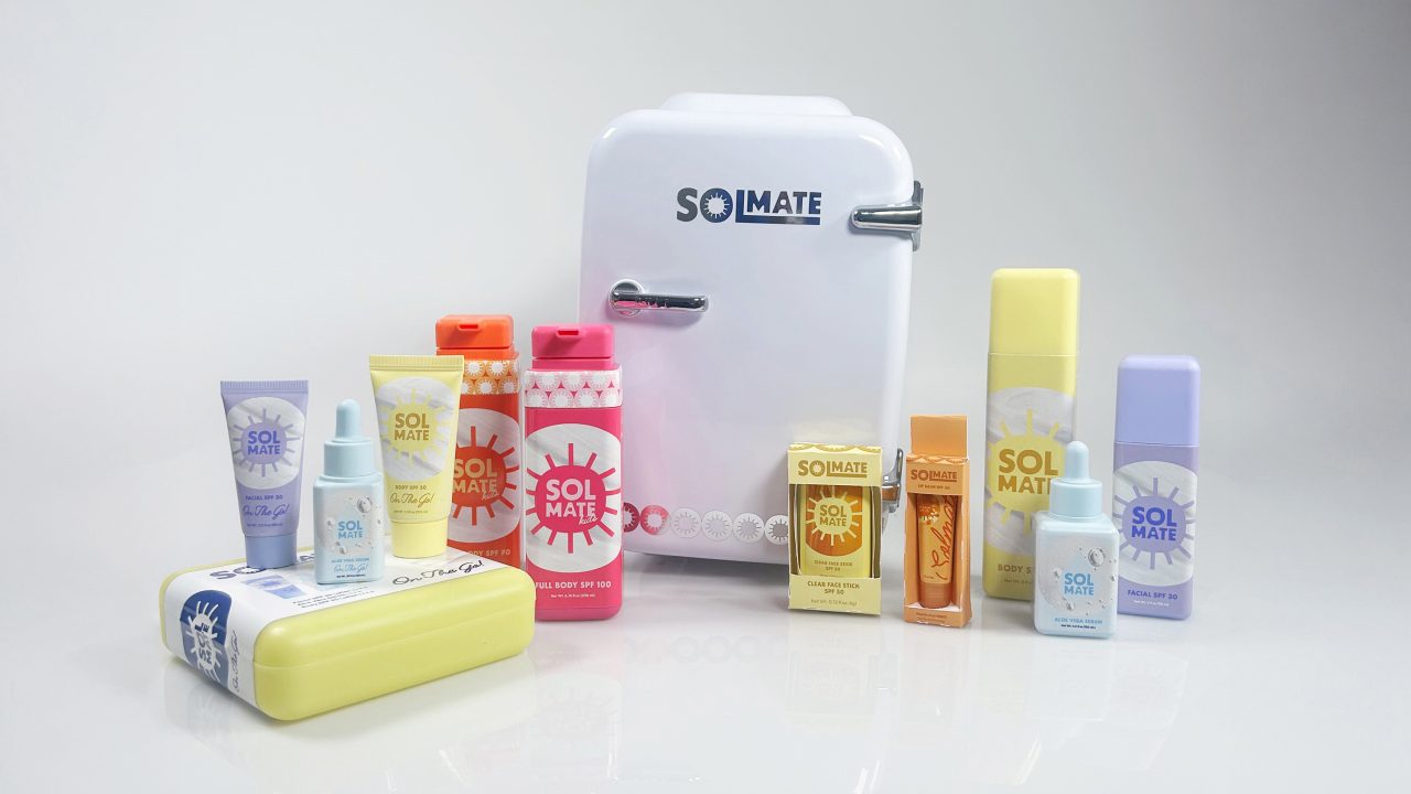 A variety of Sol Mate skincare products are displayed around a small white fridge labeled Sol Mate on a plain white background.
