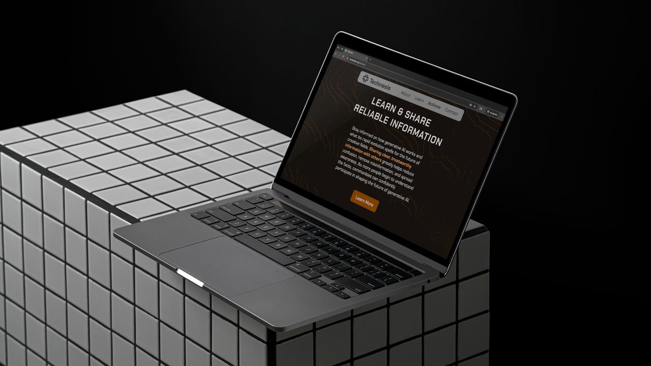 A laptop displaying a website titled Learn & Share Reliable Information rests on a large, white, grid-patterned cube against a dark background.