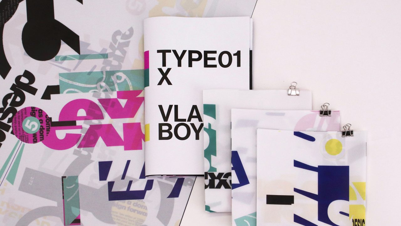 A booklet labeled TYPE01 X VLAD BOY and three clipped documents with abstract, layered text and geometric graphics are arranged on a surface with similar printed designs.