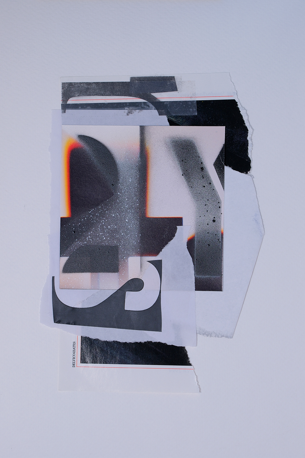 Abstract collage of torn black and white paper with spray paint textures, layered on a light background.