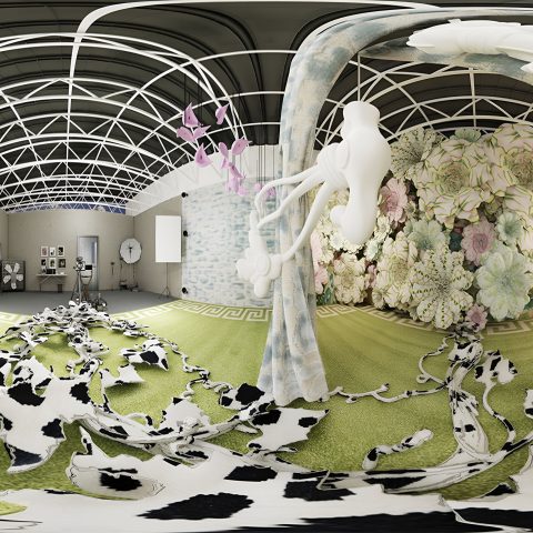 Art installation with green and white flooring, cowhide patterns, floral mural, abstract sculptures, and framed pictures on walls in a brightly lit, modern gallery space.